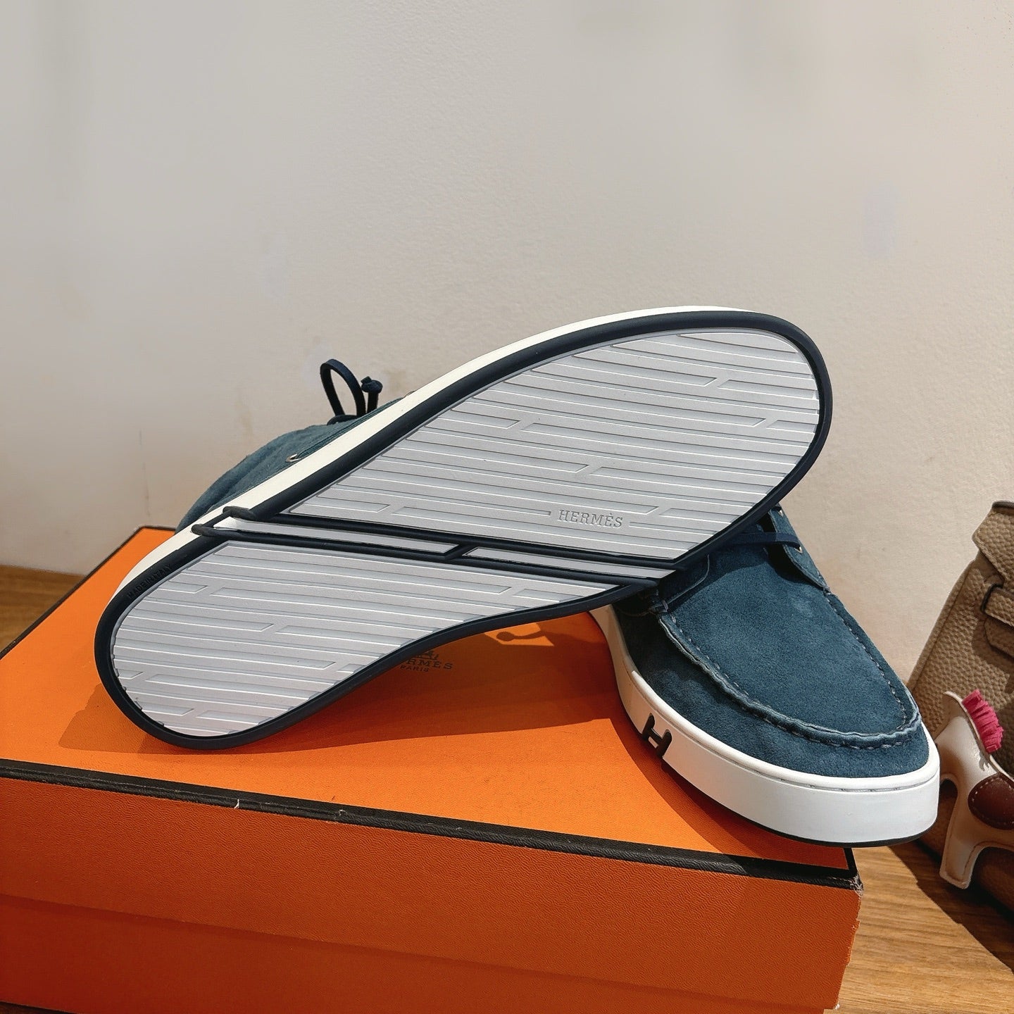 Unisex blue suede shoes outsole view with white tread sole and dark trim