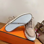 Hermes unisex gray suede sneakers, outsole view with textured tread on white sole.