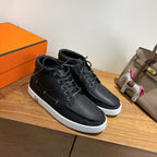Hermes black lace-up sneakers, white sole and black laces, side view pair