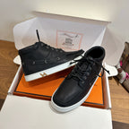 Hermes black high-top sneakers, white midsoles, visible side H detail and laces