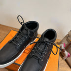 Hermes black lace-up sneakers close-up, textured leather, metal eyelets