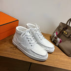 White lace-up sneakers, leather texture with gold H heel accent