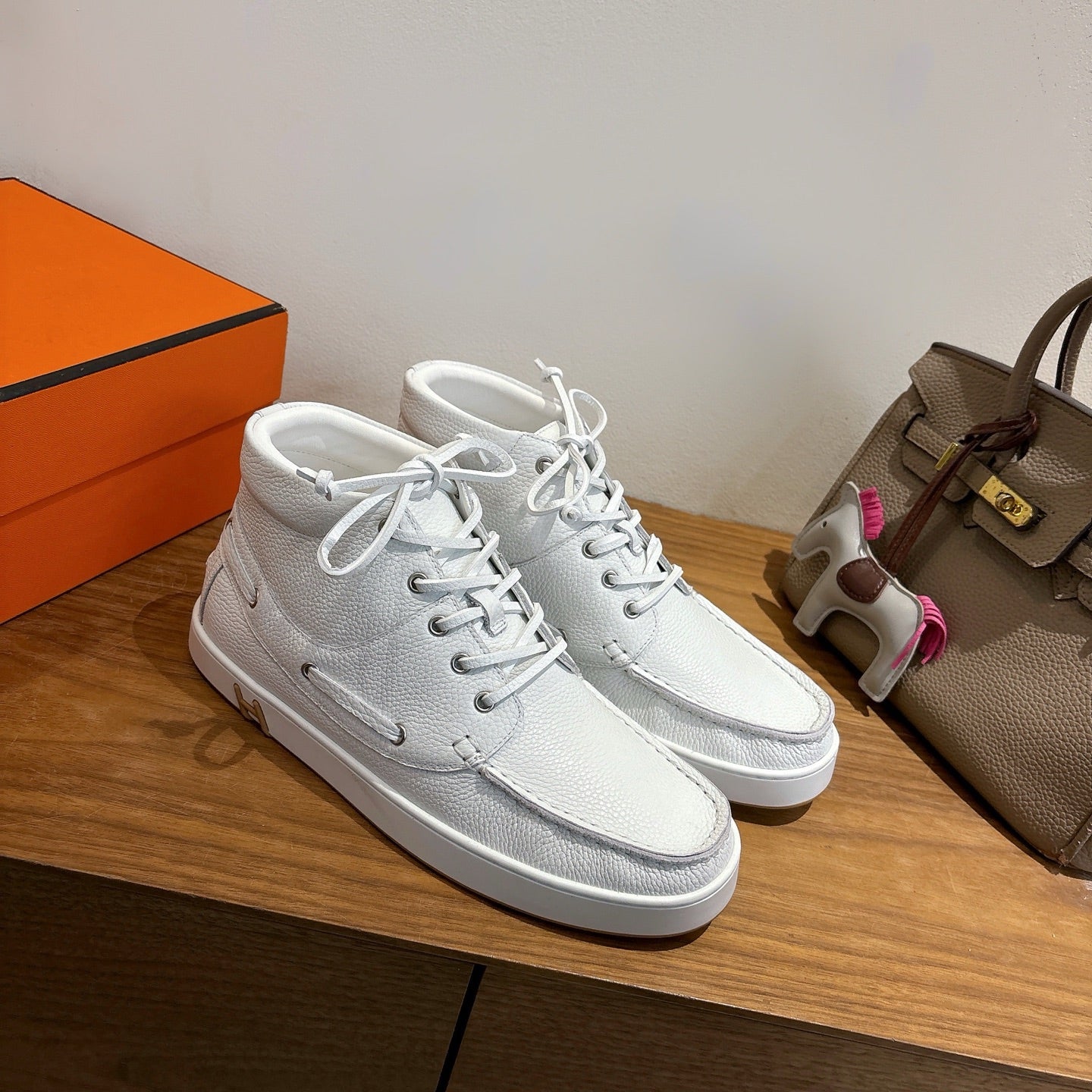 White lace-up sneakers, leather texture with gold H heel accent