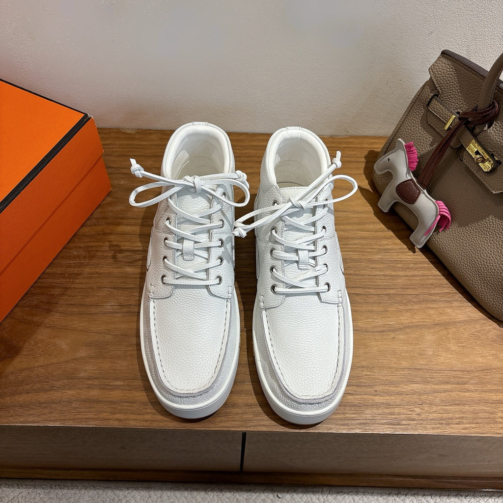 White low-top sneakers, lace-up leather, gold H detail on side