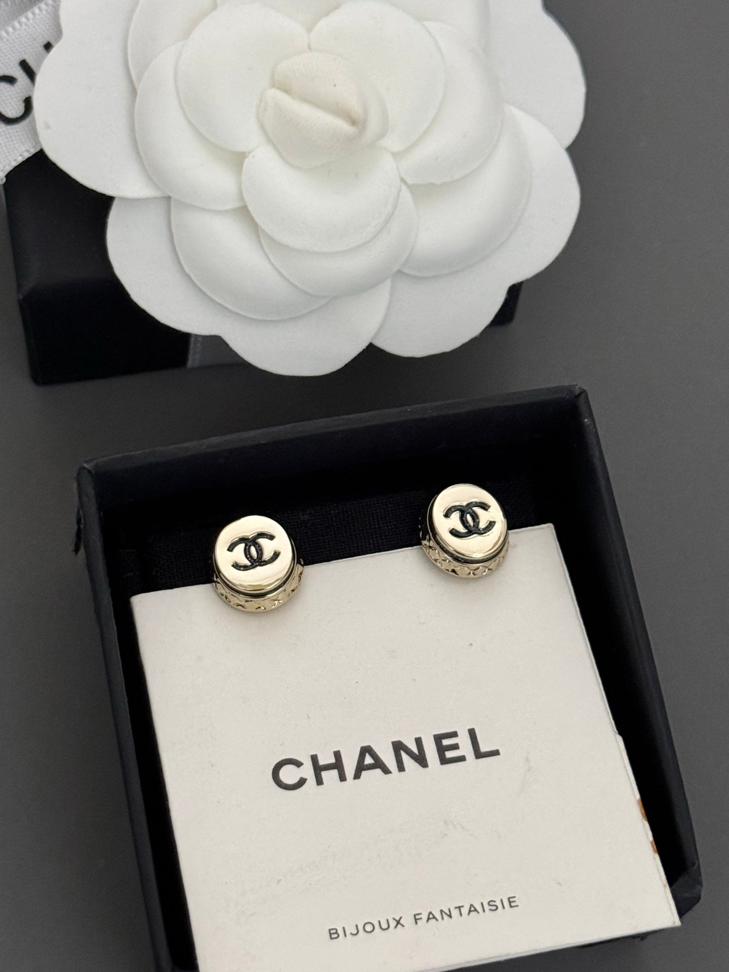 Gold-tone Chanel CC stud earrings, round bezel with black logo detail