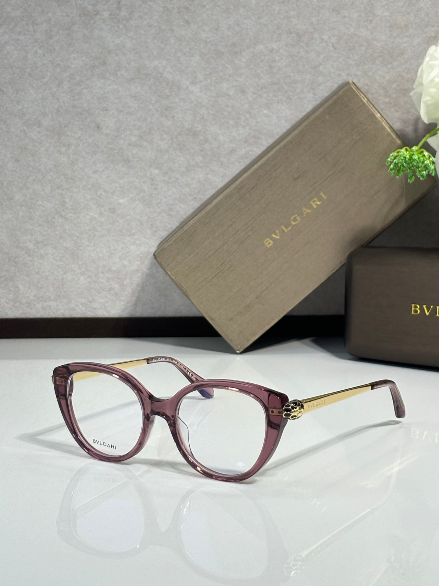 Burgundy oversized round glasses with clear lenses and gold-tone hinges
