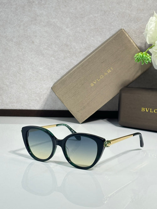Black oversized round sunglasses with blue gradient lenses and gold-tone hinges