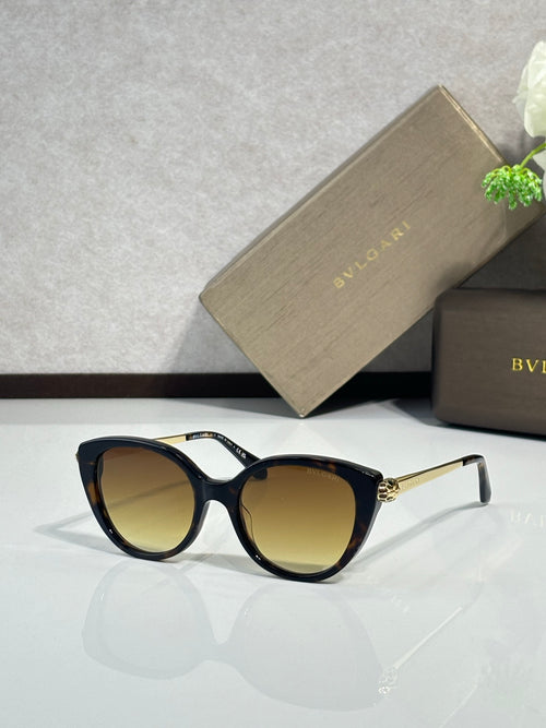 Black oversized round sunglasses with warm yellow lenses and gold-tone hinges