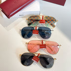 Gucci glasses stacked: monogram blue pair, pink pair, and dark pair with gold frames
