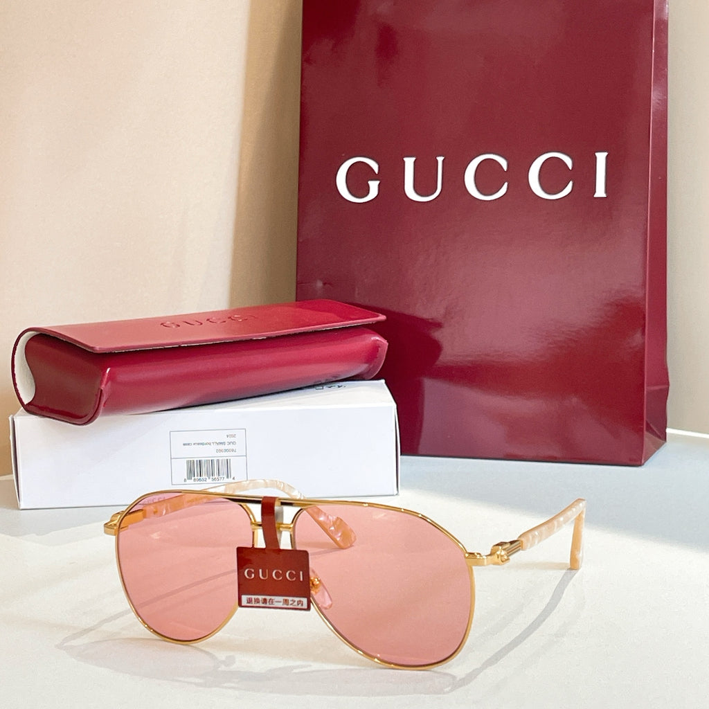 Gucci glasses with gold-tone frames and pink mirrored lenses, with metal temples