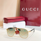 Gucci glasses with gold-tone frames and brown monogram lenses, with slim metal temples