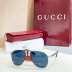 Gucci glasses with gold-tone frames and blue mirrored lenses, with sleek metal temples