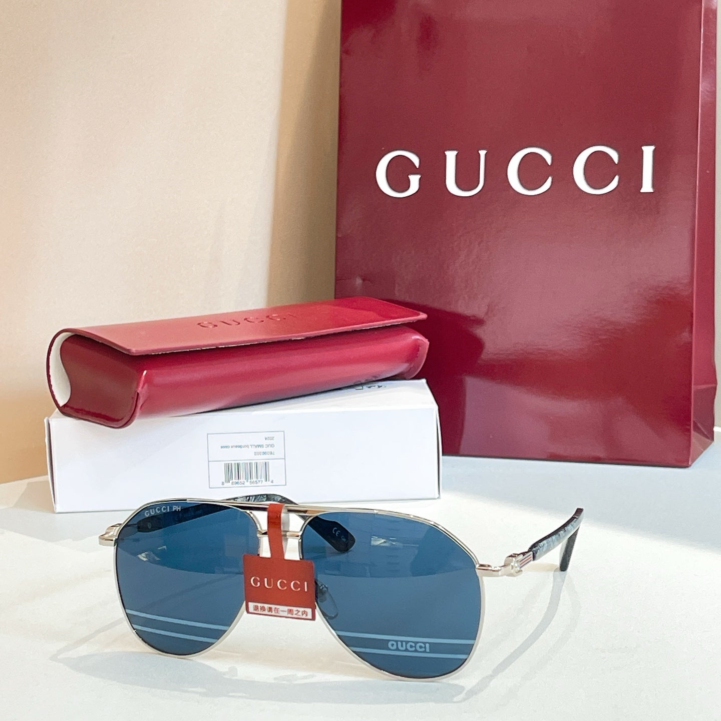 Gucci glasses with gold-tone frames and blue mirrored lenses, with sleek metal temples