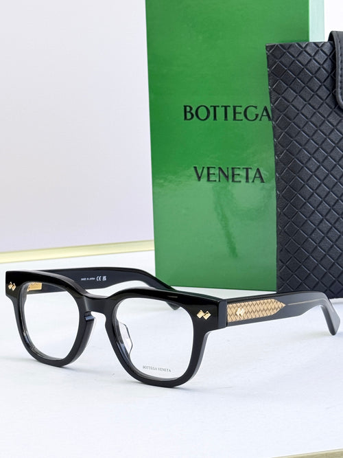 Bottega Veneta eyeglasses with black frames and gold textured temples.