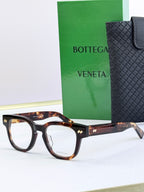 Bottega Veneta eyeglasses with tortoiseshell frames and gold textured temples.