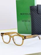 Bottega Veneta eyeglasses with gold-toned frames and gold textured temples.