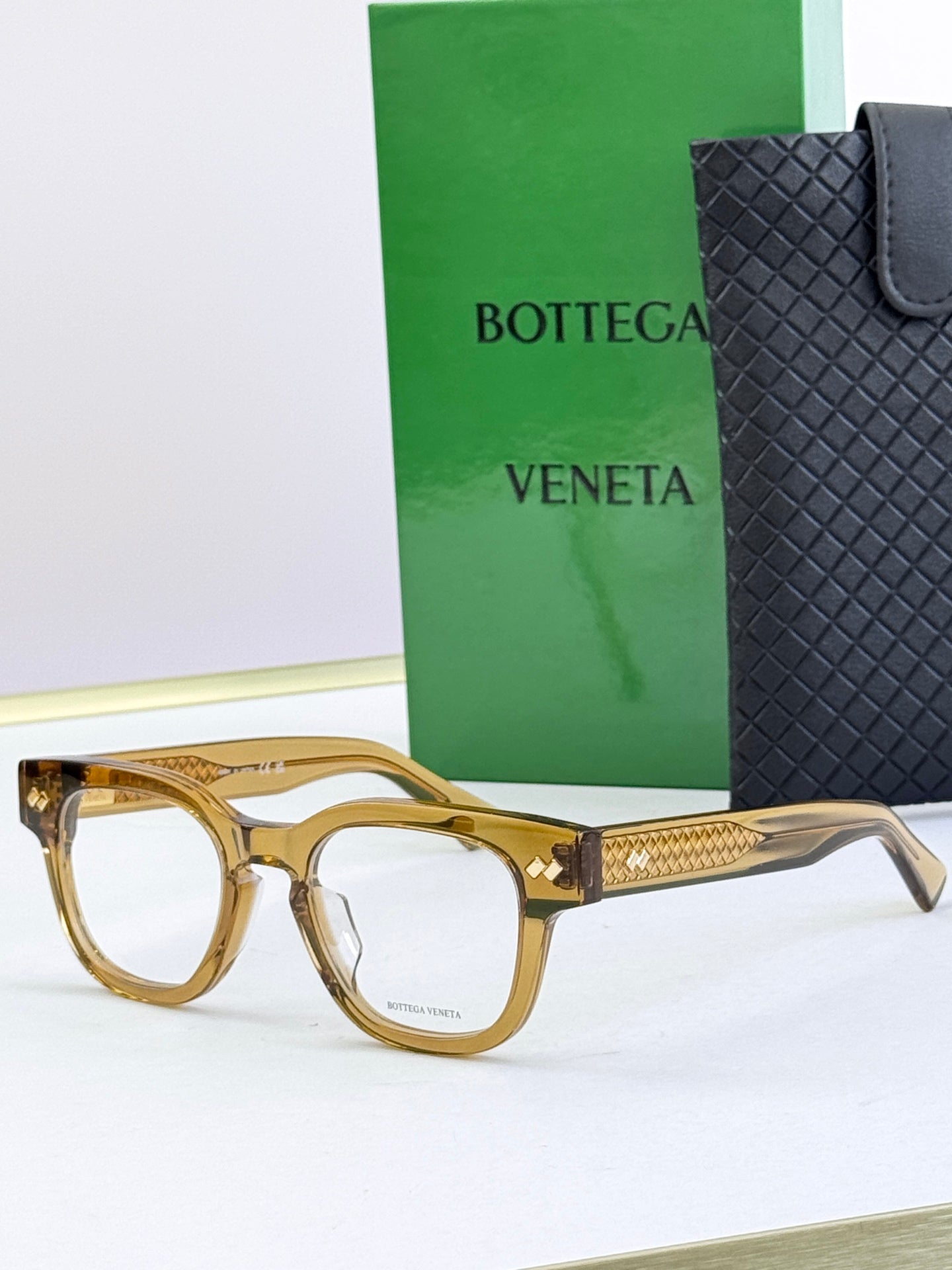 Bottega Veneta eyeglasses with gold-toned frames and gold textured temples.