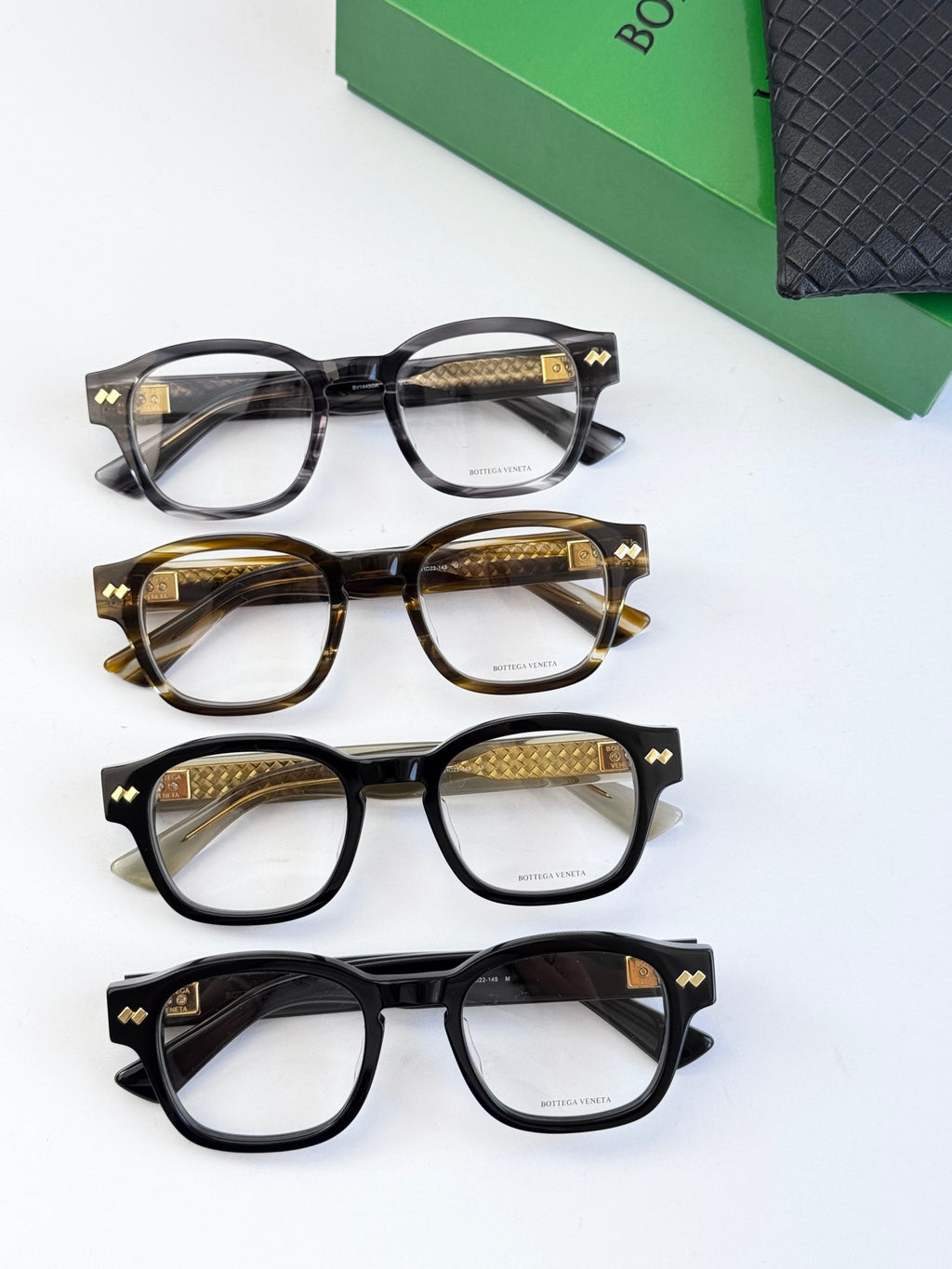 Assorted eyeglasses with black and tortoiseshell round frames and gold temples