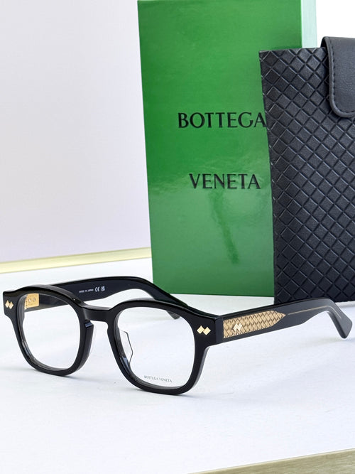 Bottega Veneta eyeglasses with black round frames and gold patterned temples