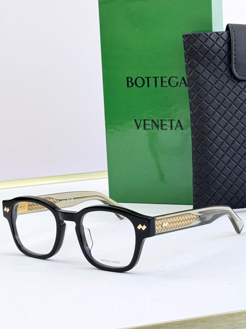 Black eyeglasses with round frames and gold patterned temple insets