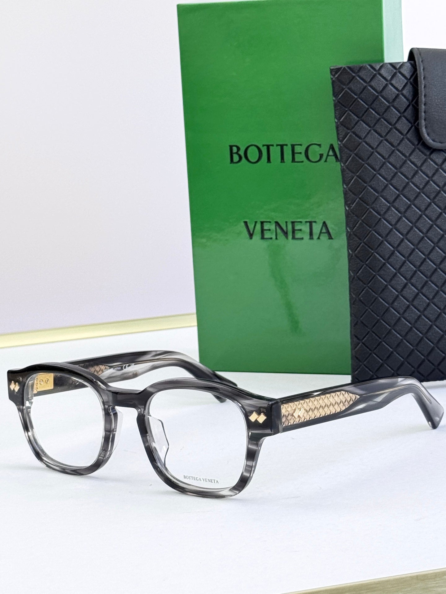 Black round eyeglasses with gold patterned temple insets