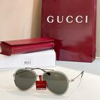 Gucci round sunglasses with dark green lenses and gold-tone metal frame.