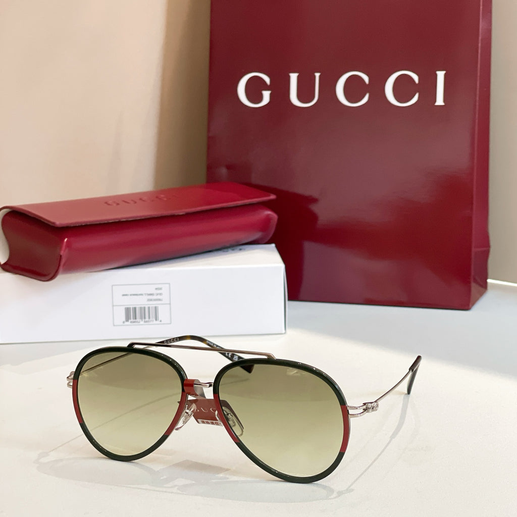 Gucci round sunglasses with light green lenses and dark frame.