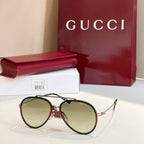 Gucci round sunglasses with light green lenses and dark frame.