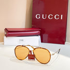 Gucci round sunglasses with amber lenses and gold-tone metal frame.
