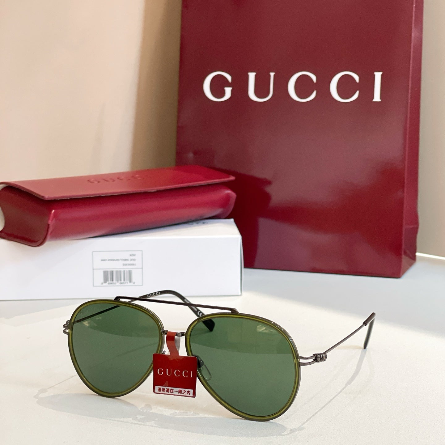 Gucci round sunglasses with green lenses and dark green frame.