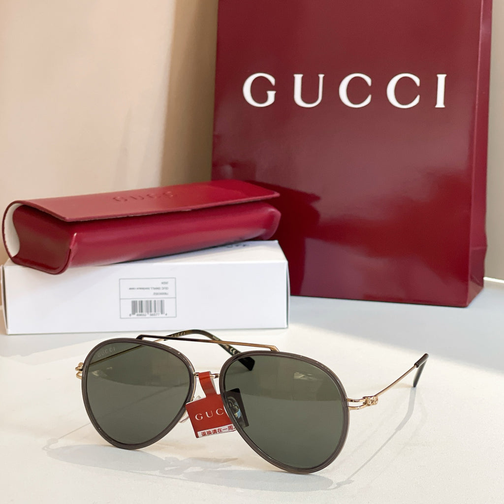 Gucci round sunglasses with olive lenses and tortoiseshell frame.