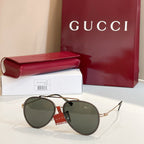 Gucci round sunglasses with olive lenses and tortoiseshell frame.
