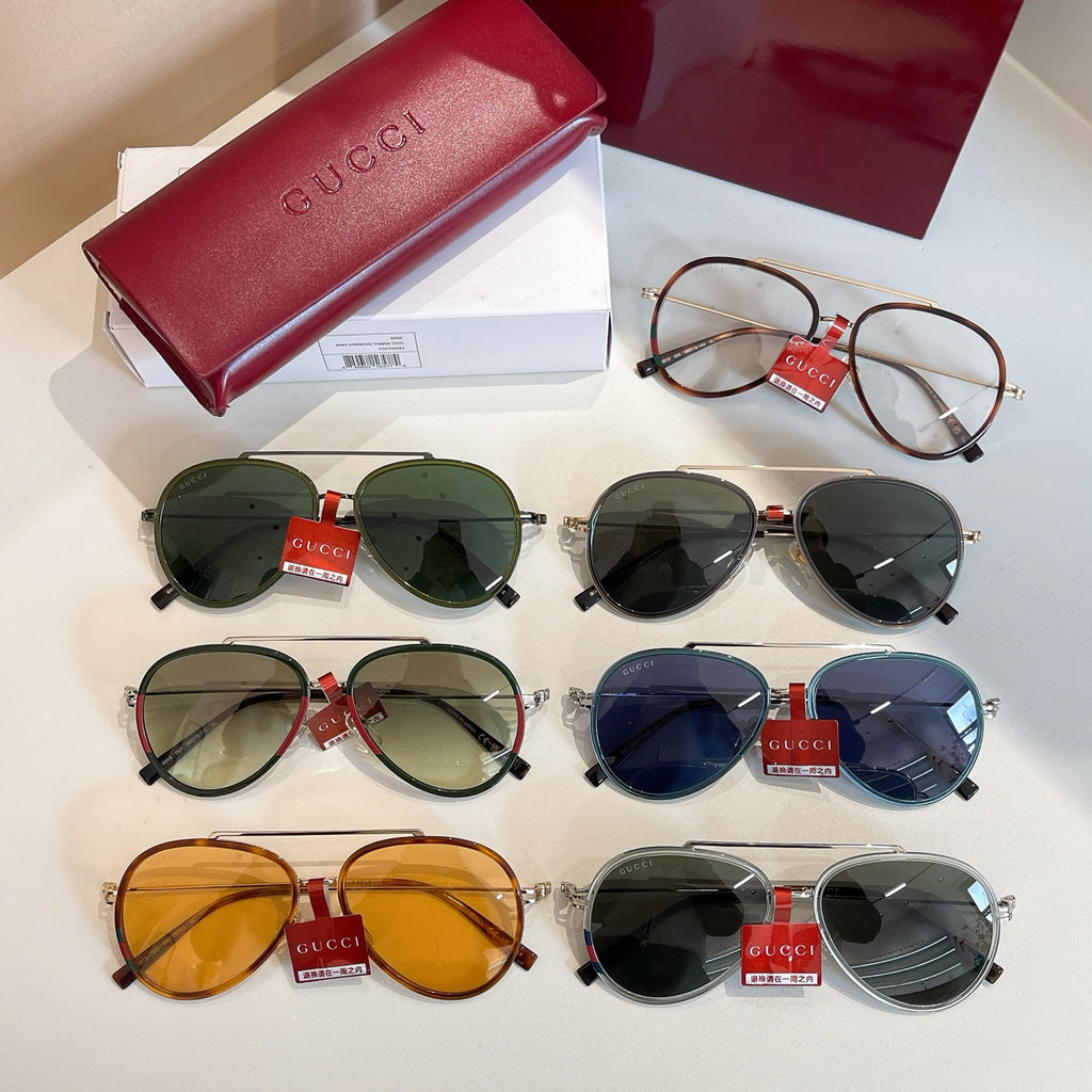 Assorted Gucci round sunglasses with green, blue, orange, and black lenses.