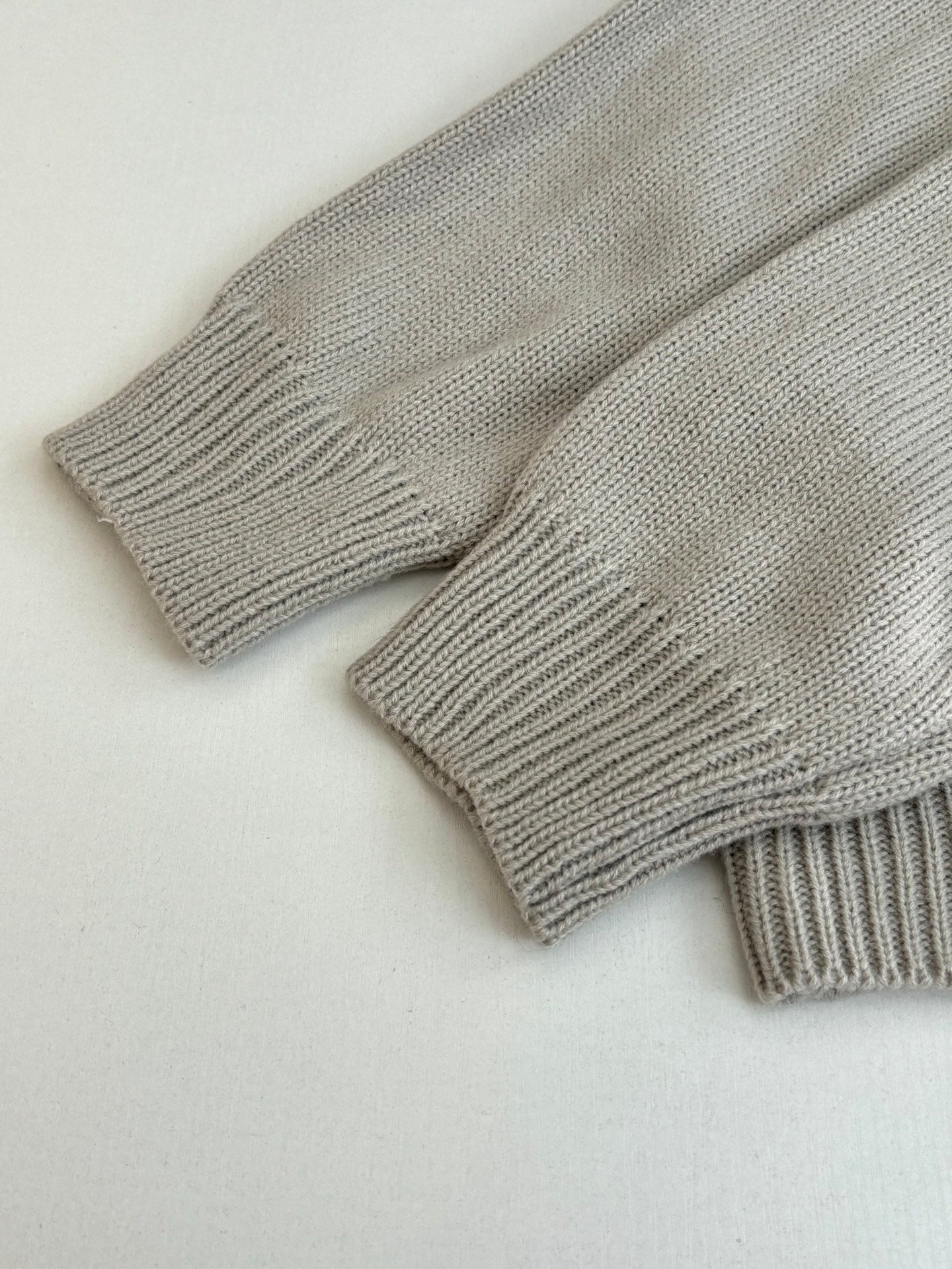 Light gray knit sweater cuffs with ribbed cuffs and textured knit weave