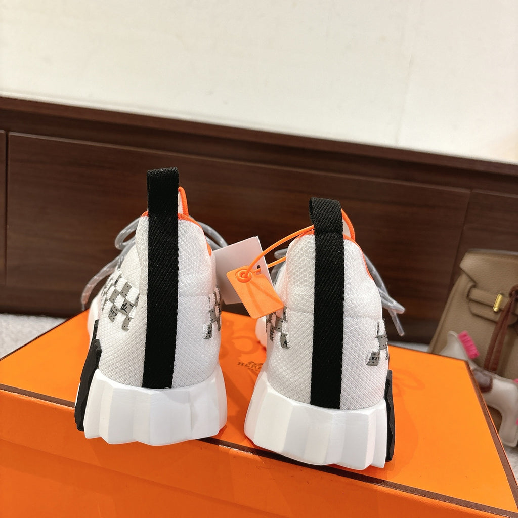 Hermes unisex sneakers back view, white knit with orange trim and black heel pull tabs