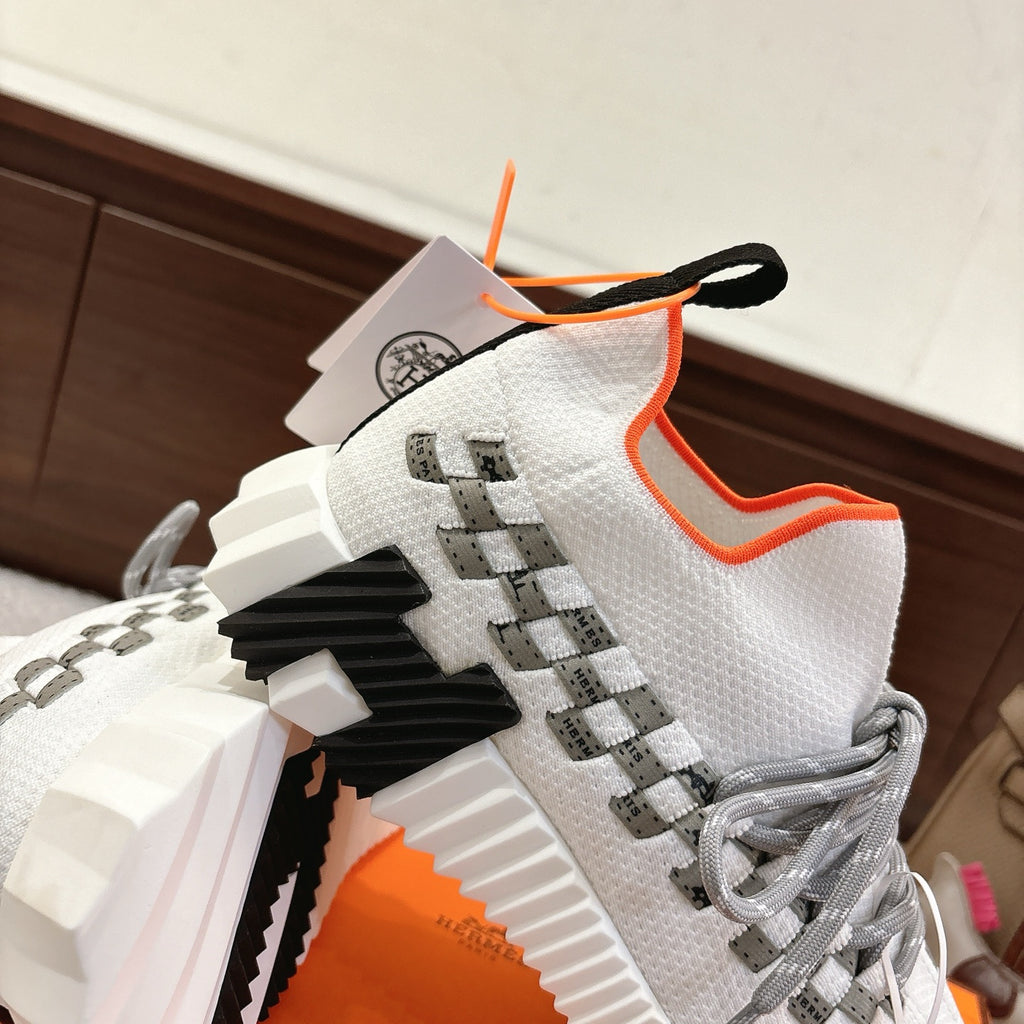 Hermes unisex sneakers, white knit upper with gray laces, orange trim, textured sole