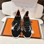 Hermes unisex sneakers: black knit, orange trim, white checker pattern, white sole