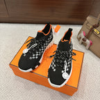 Hermes unisex sneakers: black knit with white checker band, orange collar, black laces, white sole