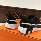 Hermes unisex black sneakers with orange tag, white heel and sole stripe, lace-up
