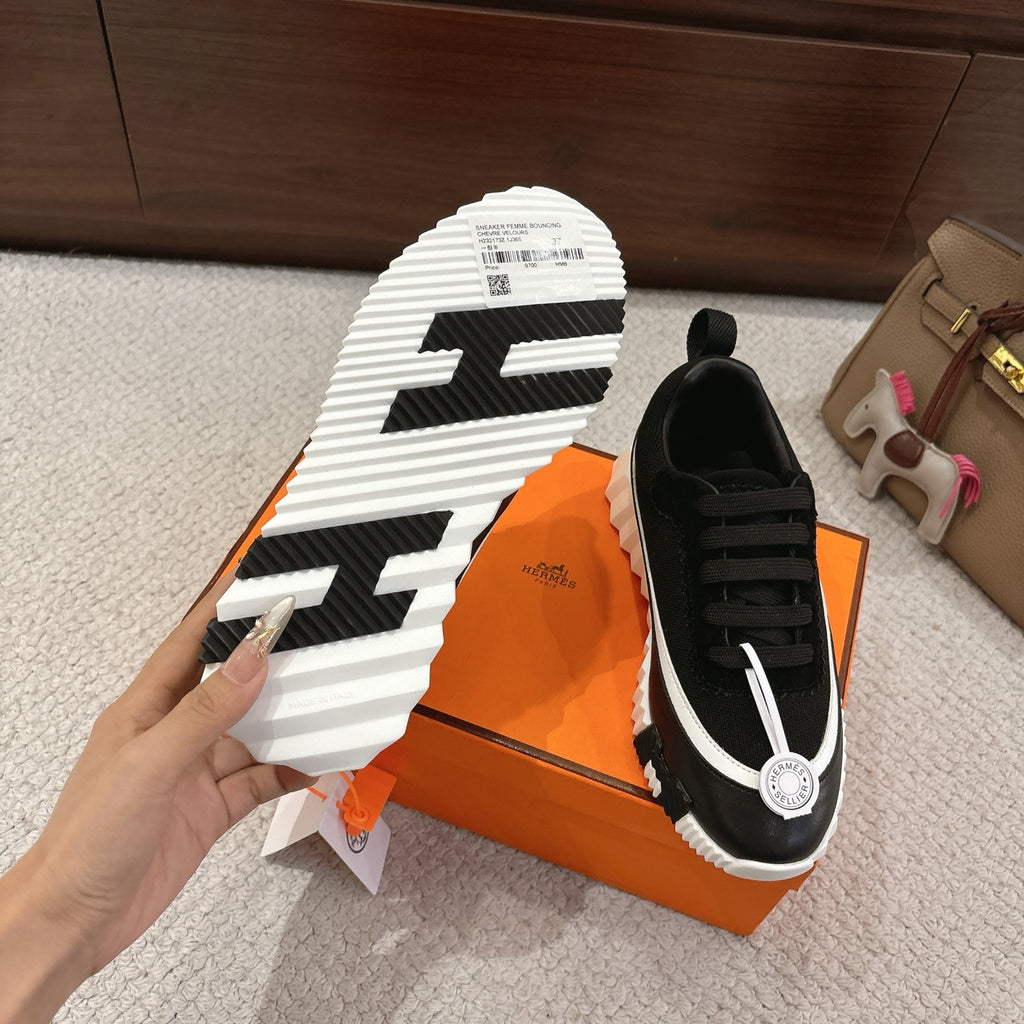 Hermes unisex black sneakers sole view, thick white tread, lace-up upper