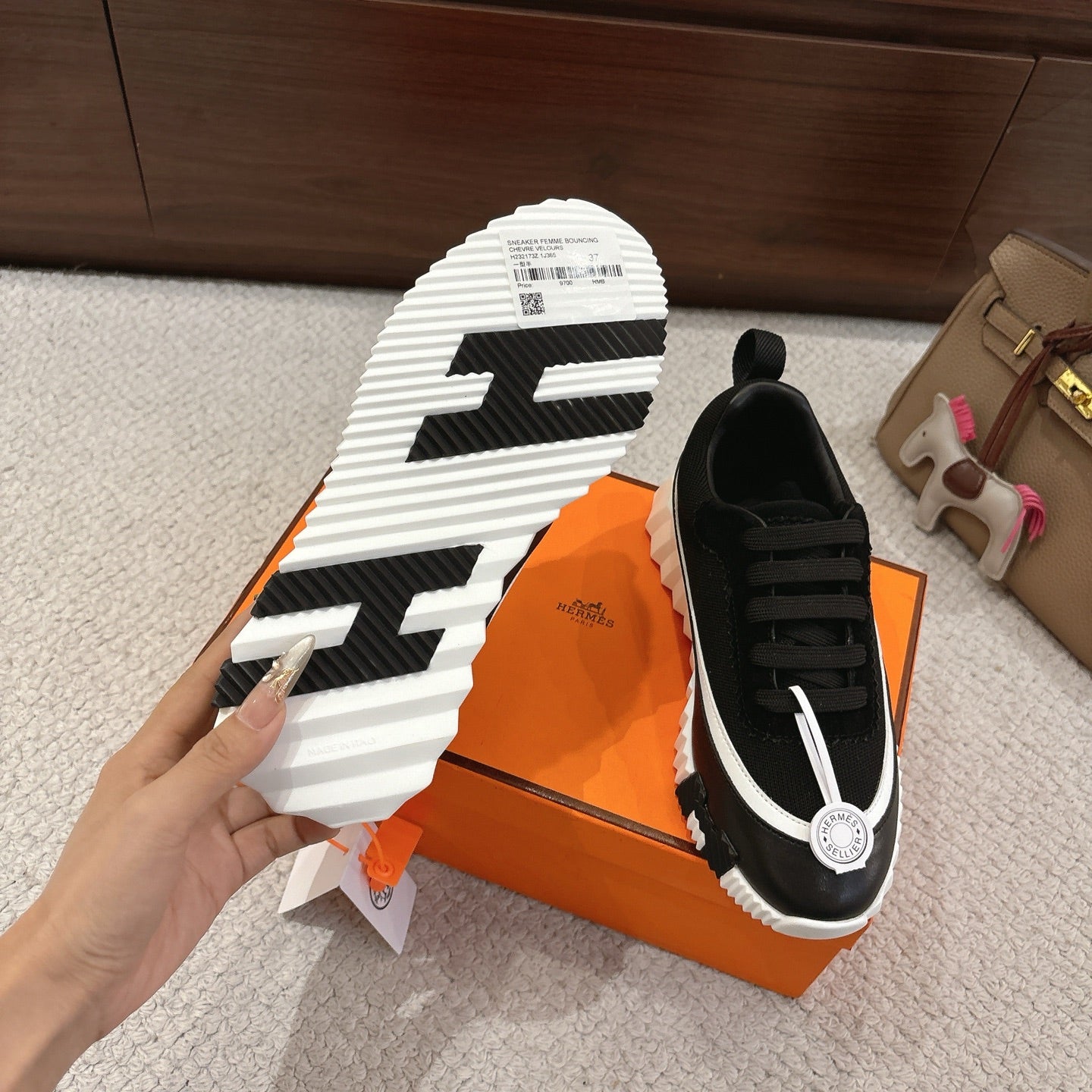 Hermes unisex black sneakers sole view, thick white tread, lace-up upper