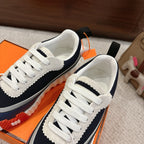 Unisex navy and white sneakers side-by-side with white laces and thick sole