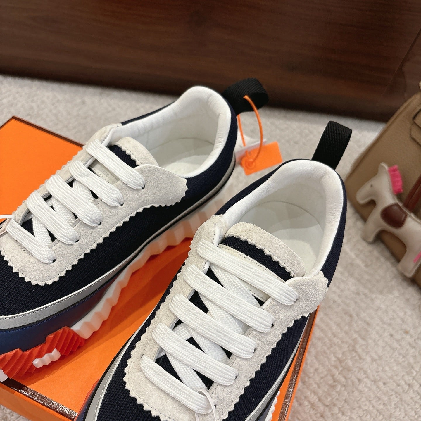 Unisex navy and white sneakers side-by-side with white laces and thick sole
