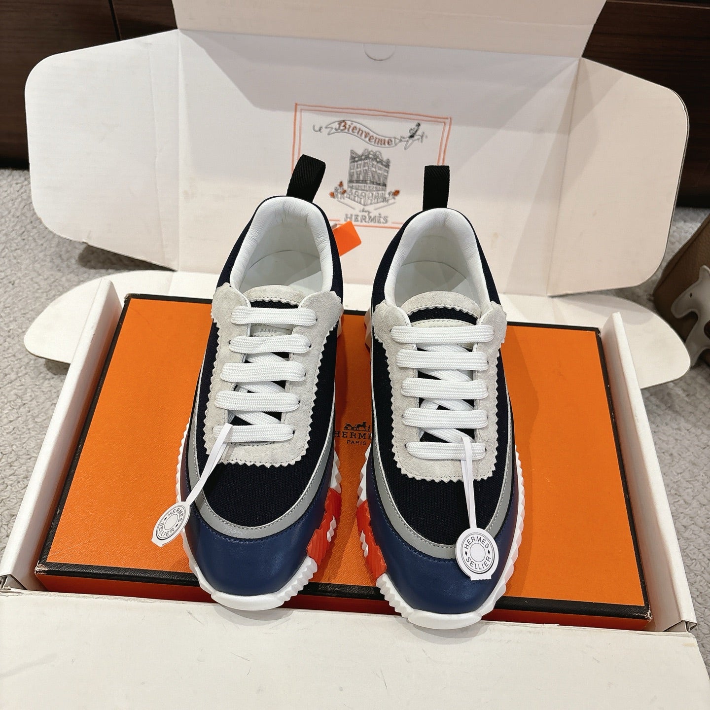 Unisex low-top sneakers in navy and white with white laces and chunky sole