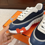 Unisex sneaker upper in navy with white laces, gray trim, and ridged sole