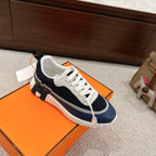 Unisex navy and white sneakers with white laces and cushioned, grippy sole