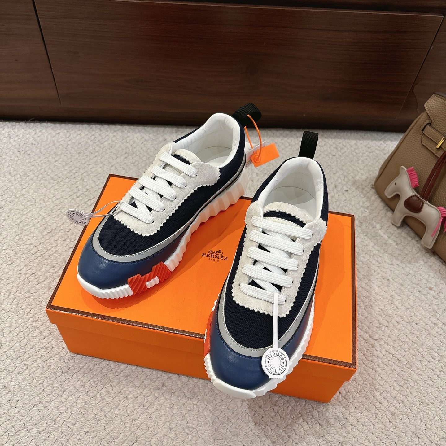 Pair of unisex navy and white low-top sneakers with white laces and grippy sole