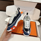 Unisex navy-and-white sneakers with white laces, textured trim, and thick sole