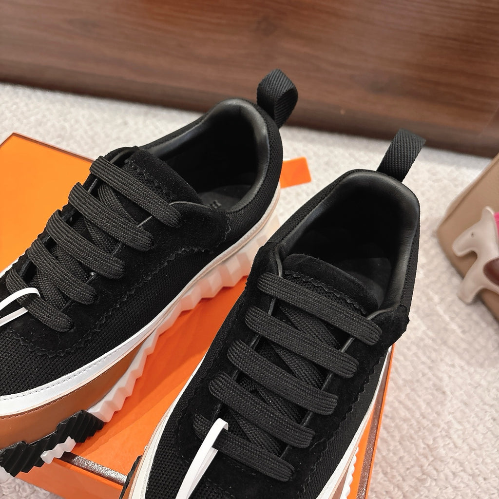 Unisex sneakers close-up showing black laces, white side stripe, and thick white sole