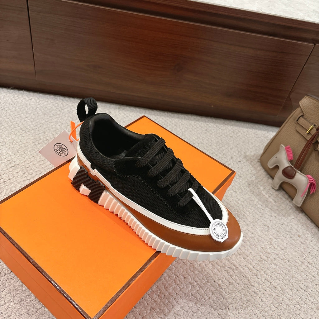 Unisex casual sneakers, black upper with tan toe panel, white sole with raised tread